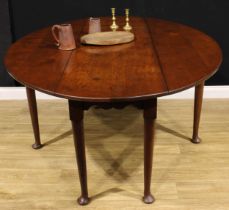 An 18th century style oak Irish wake table, oval top with fall leaves above a deep shaped frieze,