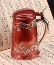 An American Art Nouveau silver overlaid mixed metal tankard, applied with stylised flowers and