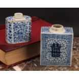 A Chinese canted rectangular tea caddy, painted in tones of underglaze blue with flowers and leafy