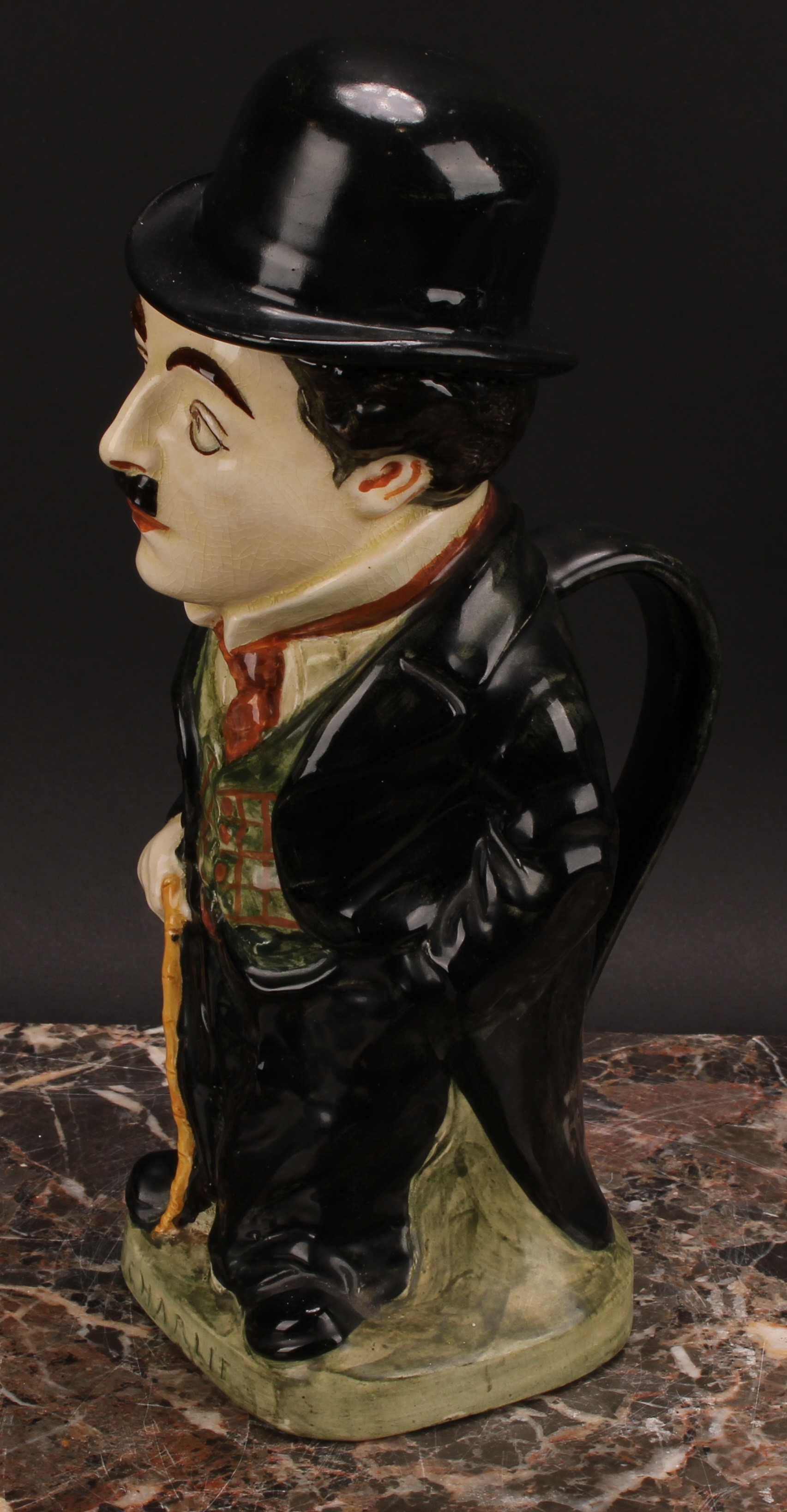 A Royal Doulton jug and cover, modelled as Charlie Chaplin, he stands wearing baggy black suit - Bild 5 aus 7