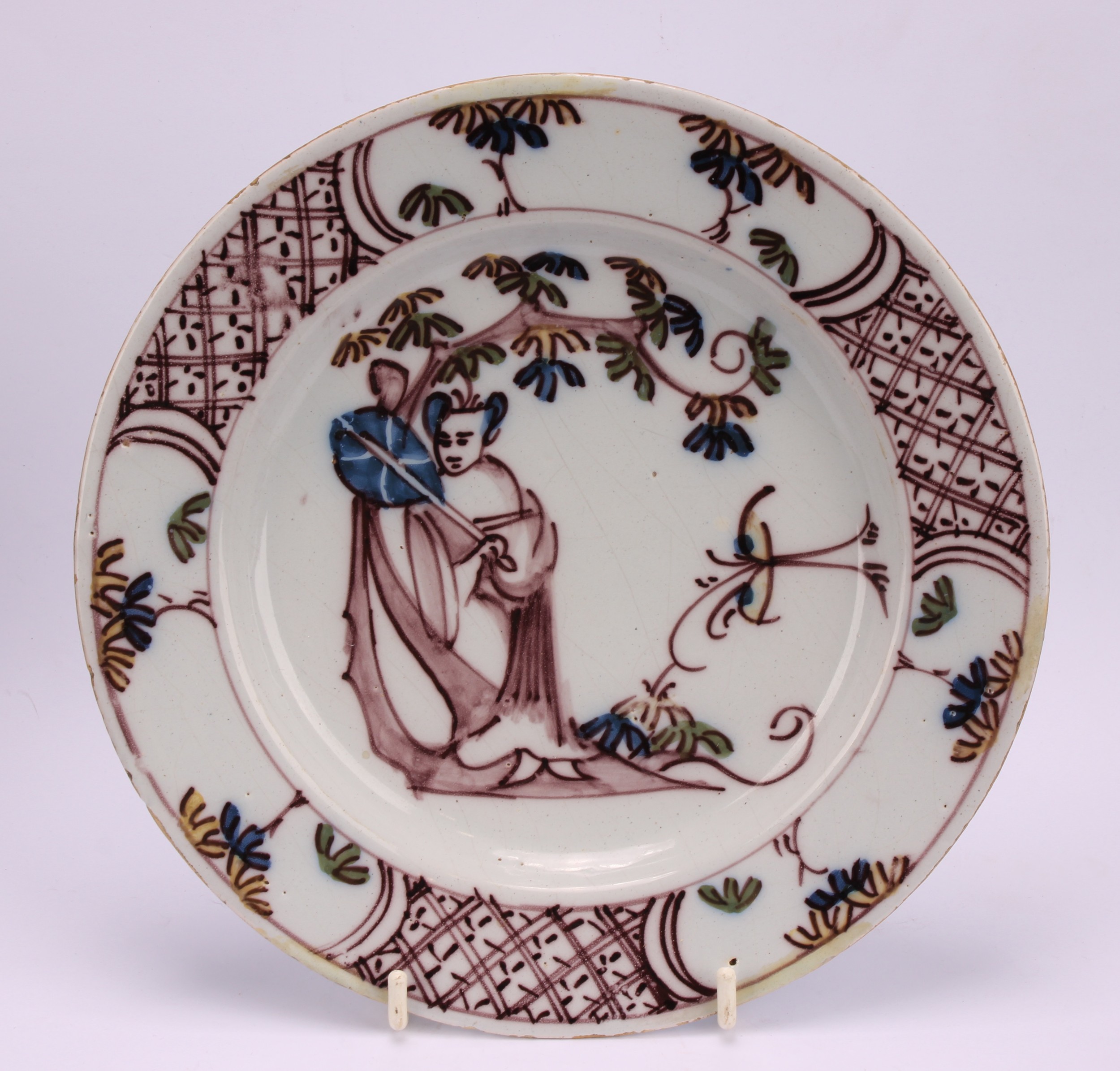 An 18th century Delft circular plate, painted in the chinoiserie taste with a figure in a Chinese - Image 2 of 18