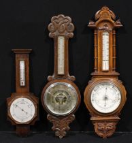 A Victorian oak aneroid wheel barometer, 19cm register inscribed Hutchinson & Co, 14 Newgate St,