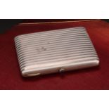 A Continental silver and enamel rounded rectangular cigarette case, banded in white, hinged cover,