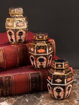 An associated set of three Royal Crown Derby 1128 Imari pattern hexagonal caddies and covers,