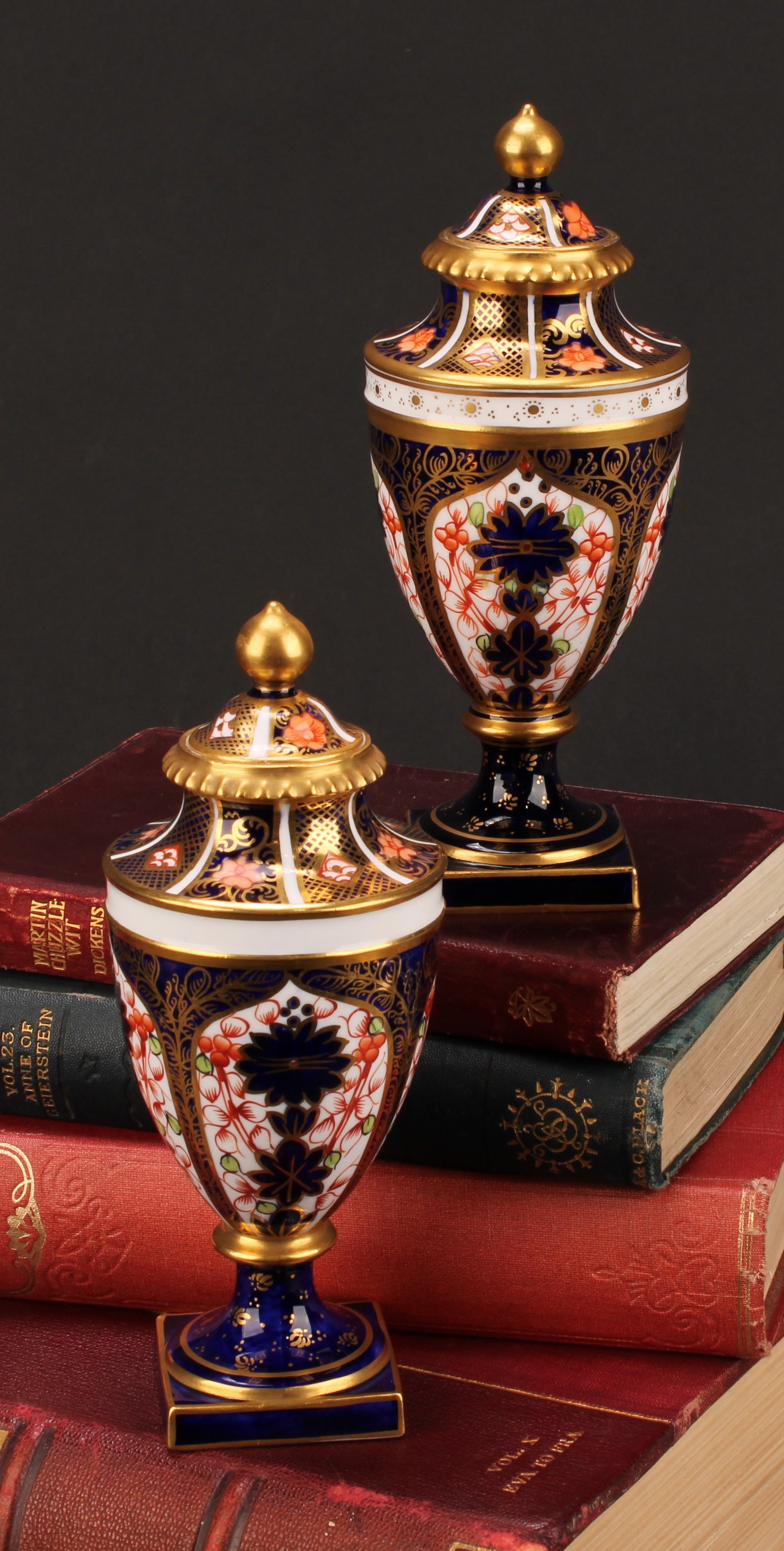 A near pair of Royal Crown Derby 1128 Imari pattern ovoid pedestal vases, domed covers, gilt