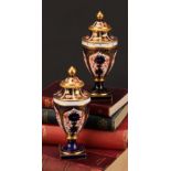 A near pair of Royal Crown Derby 1128 Imari pattern ovoid pedestal vases, domed covers, gilt