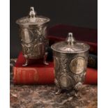 A pair of French silver coin beakers and covers, in the Renaissance taste, knop finials, shell