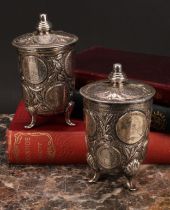 A pair of French silver coin beakers and covers, in the Renaissance taste, knop finials, shell