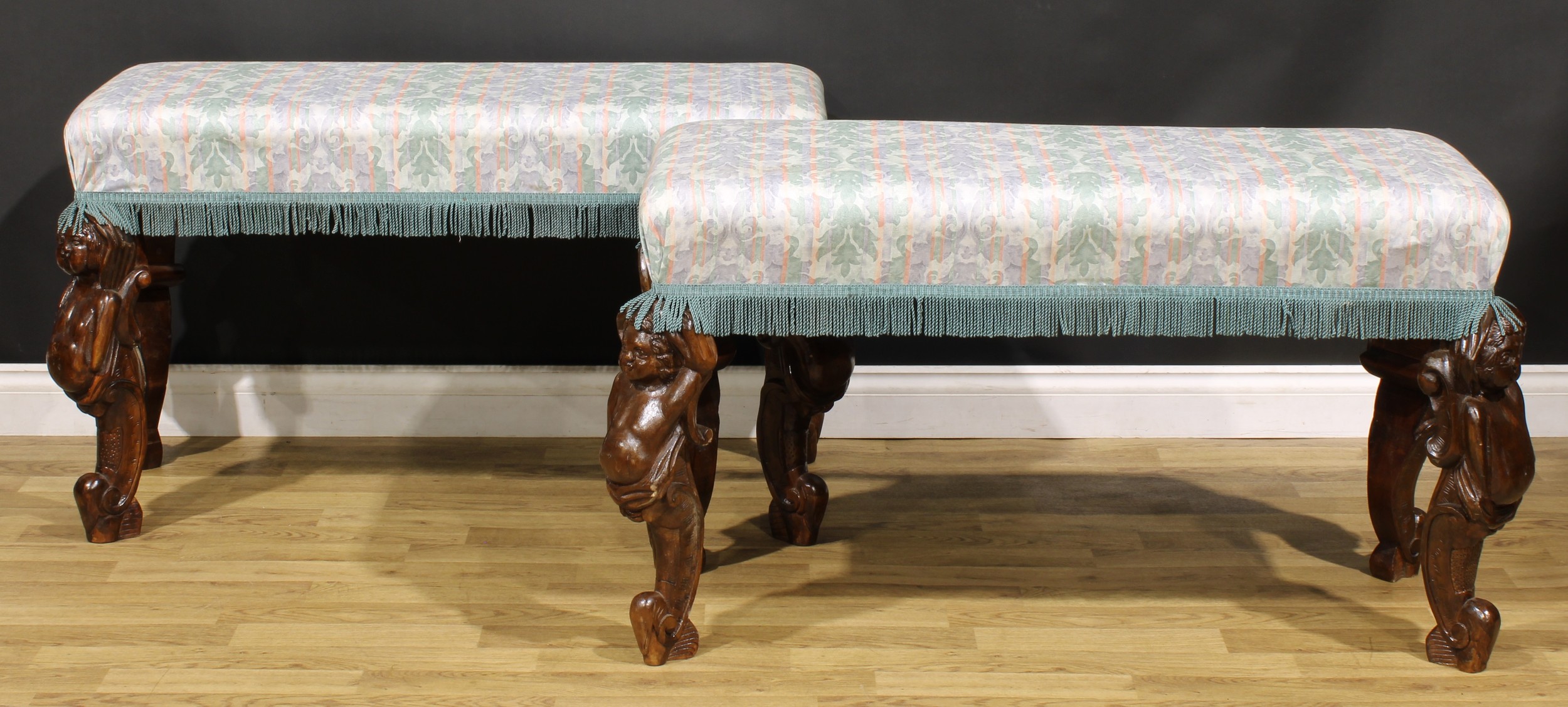 A pair of large Italian Rococo design double-width stools, stuffed-over seats, monopodial legs