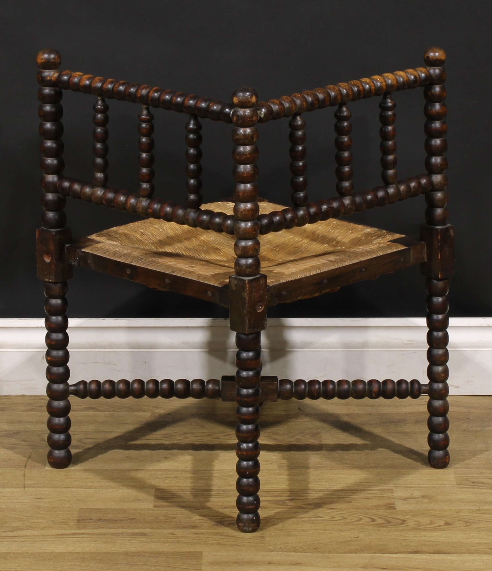 An Arts & Crafts beech bobbin-turned corner chair, of small proportions, rush seat, 60.5cm high, - Image 4 of 4