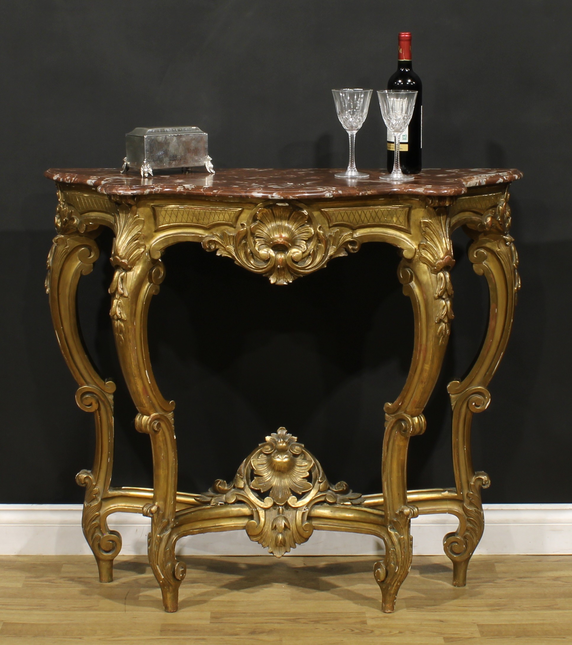 A Louis XV Revival giltwood pier table, in the Rococo taste, serpentine marble top, 93cm high, 104.