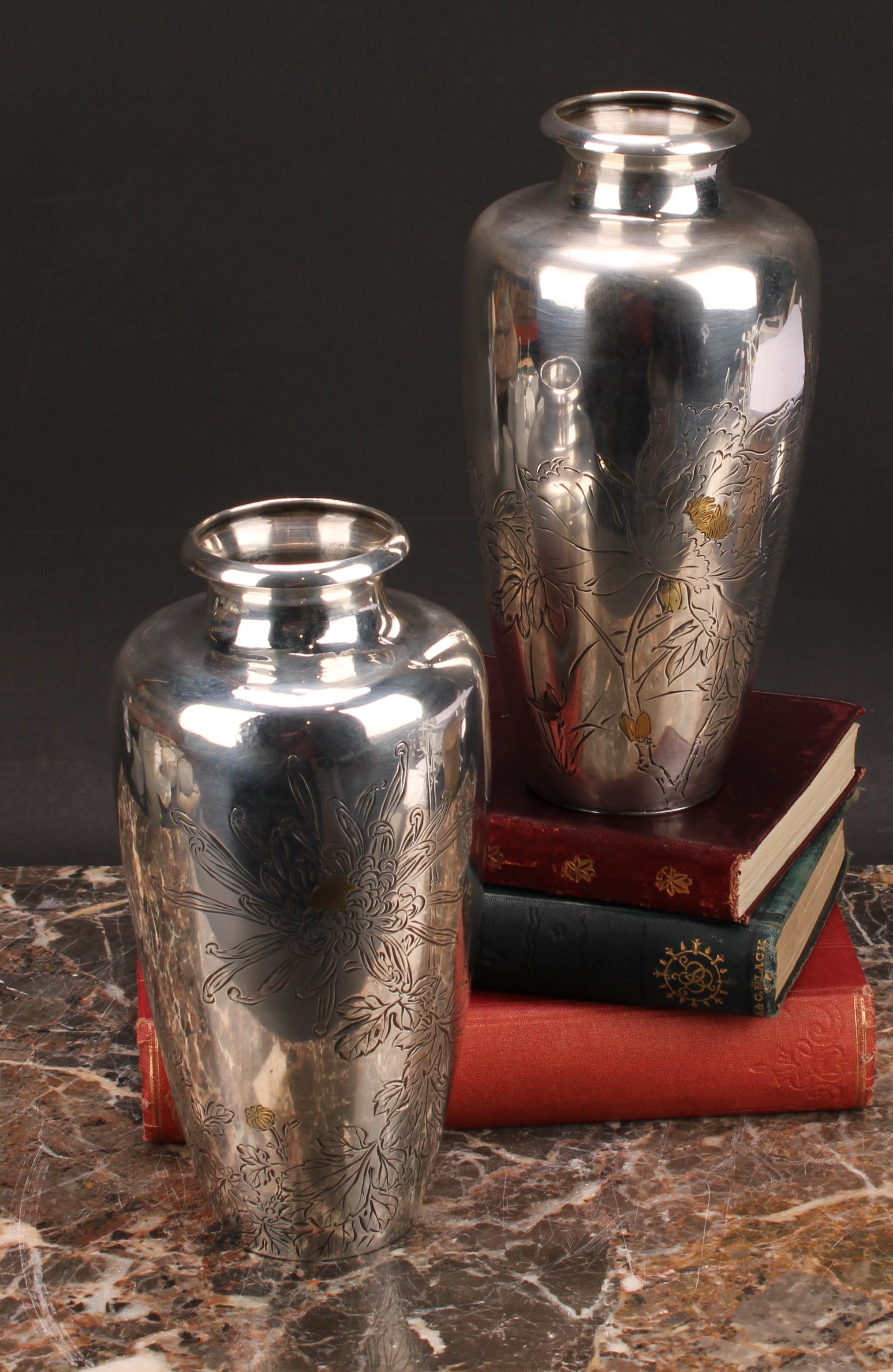 A pair of Japanese silver ovoid vases, chased with flowers picked out in gold coloured metal, 18cm