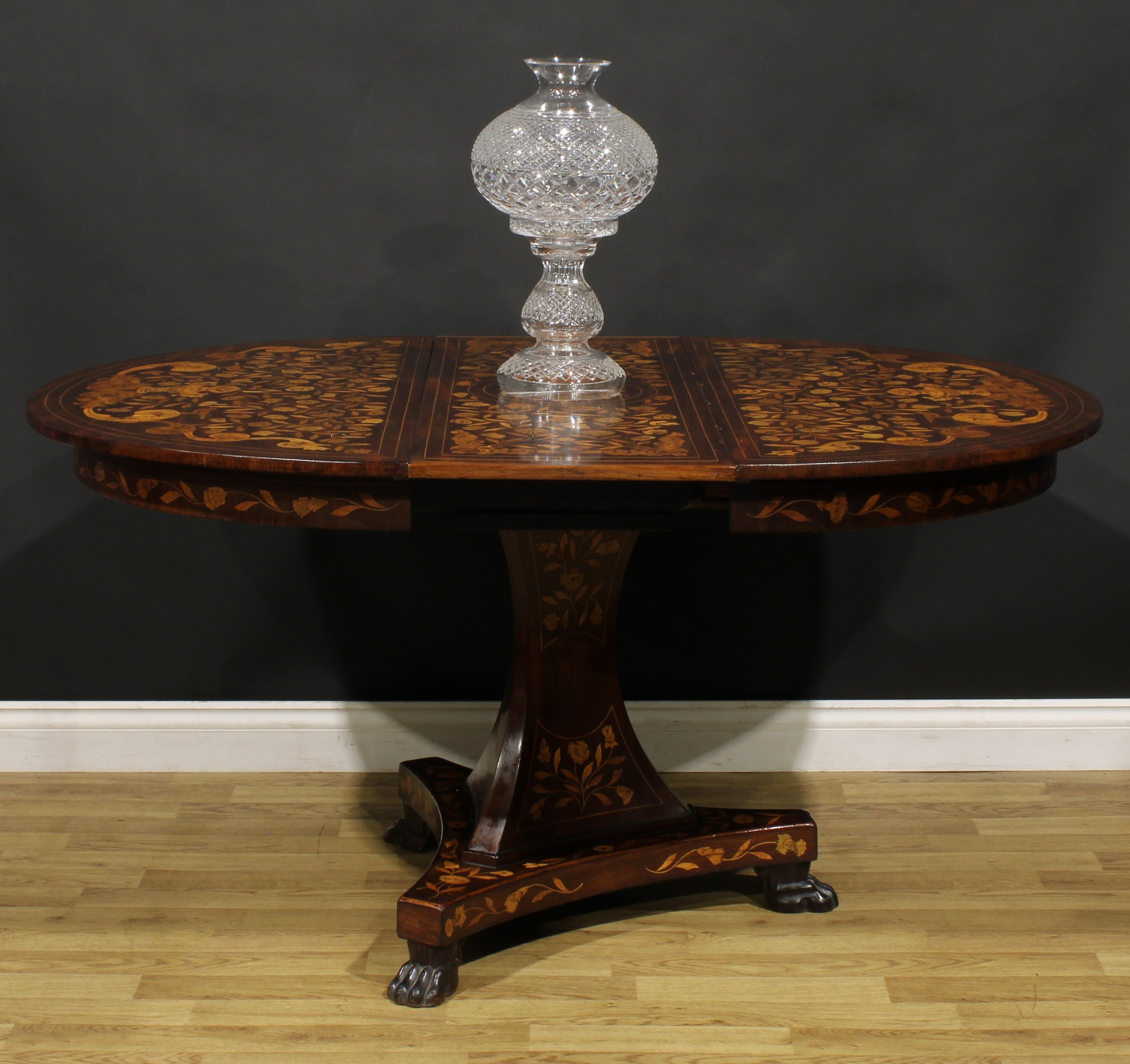 A 19th century Dutch marquetry extending dining table, discorectangular top with one additional