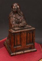 A 19th century carved oak figure, of Saint Rita of Cascia, kneeling in prayer at a prie-dieu, 18.5cm