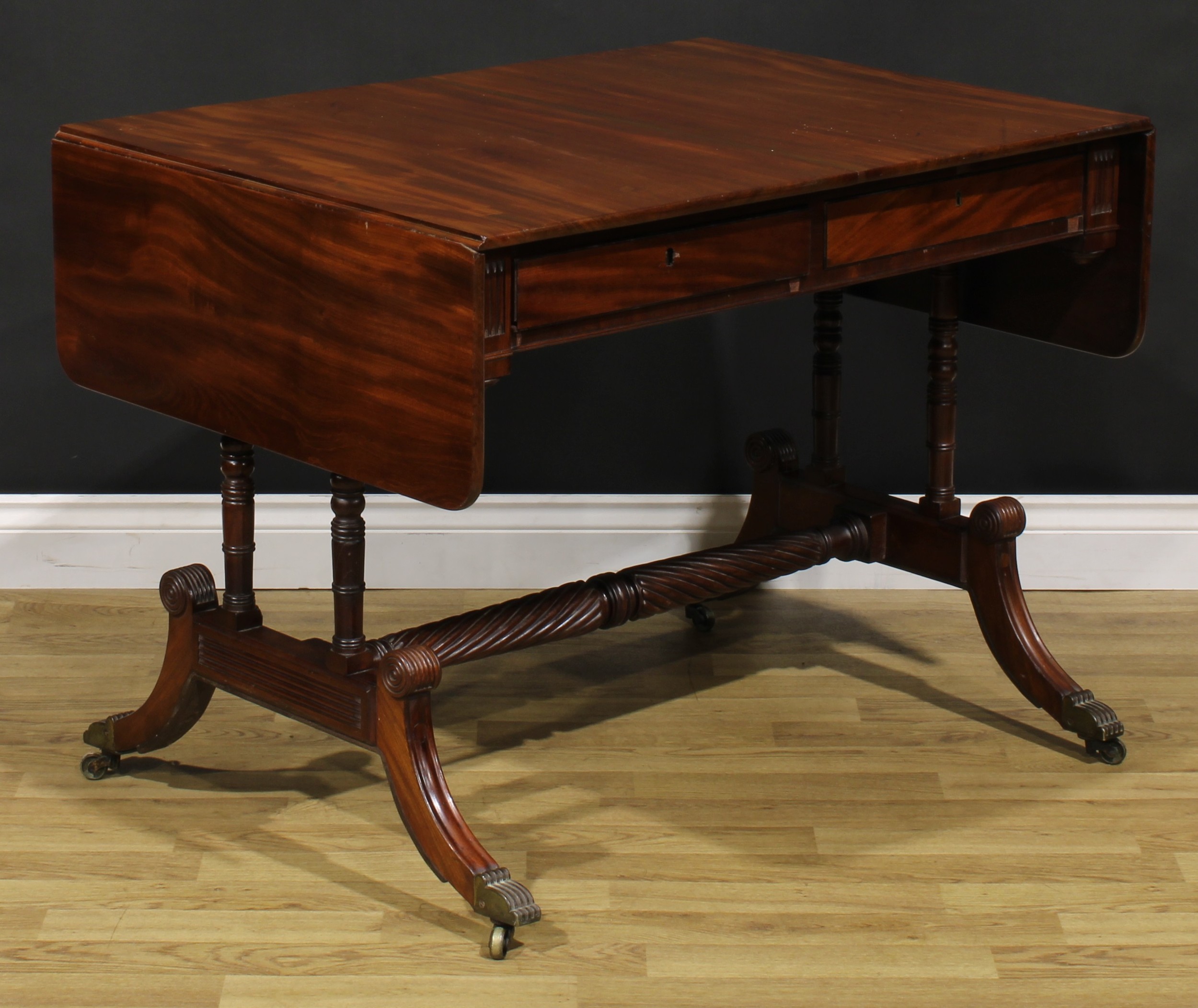 A Regency mahogany sofa table, possibly Irish, rounded rectangular top with fall leaves above a pair - Image 4 of 7