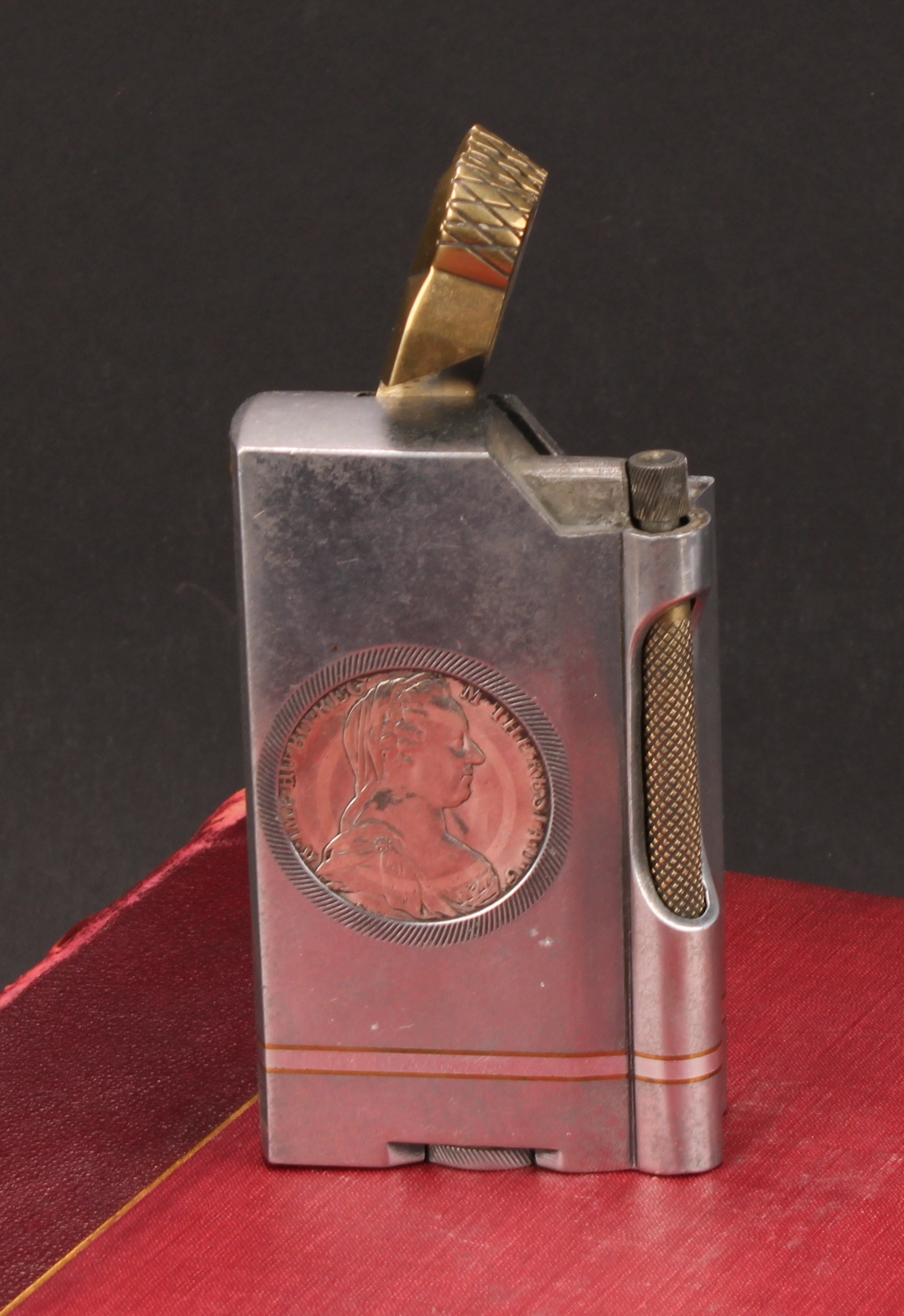 An unusual Trench Art style aluminium and brass table lighter, inset with two Austrian silver