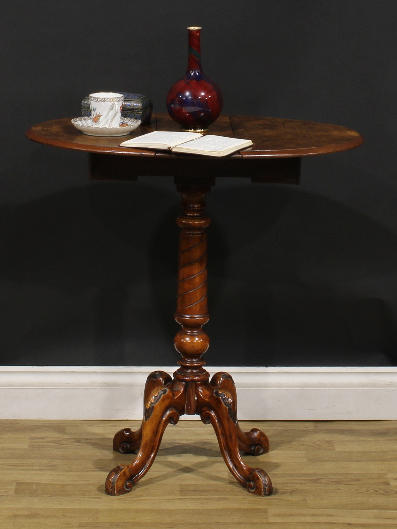 A Victorian walnut occasional table, quarter-veneered oval top with moulded edge and fall leaves,