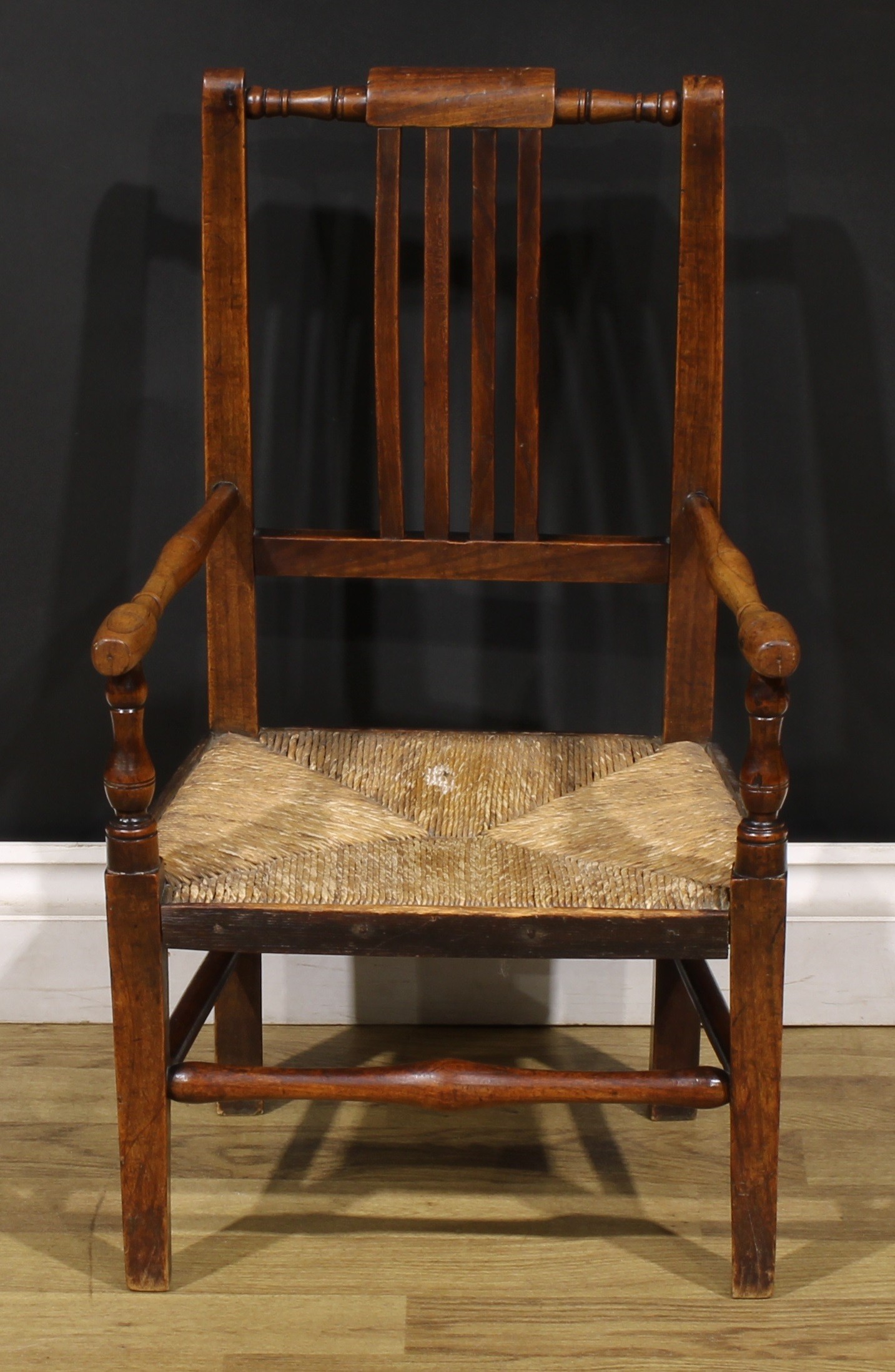 An early 19th century beech and ash child’s elbow chair, turned arms, 65cm high, 39cm wide, East