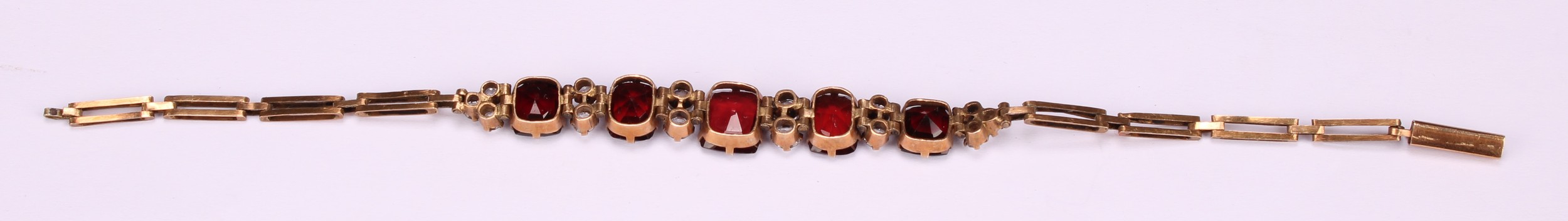 A garnet and diamond bracelet, the five graduated rectangualr mixed cut garnets divided by pairs - Image 4 of 4