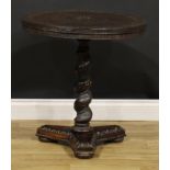 A 19th century Indian hardwood pedestal occasional table, circular top carved with deity,