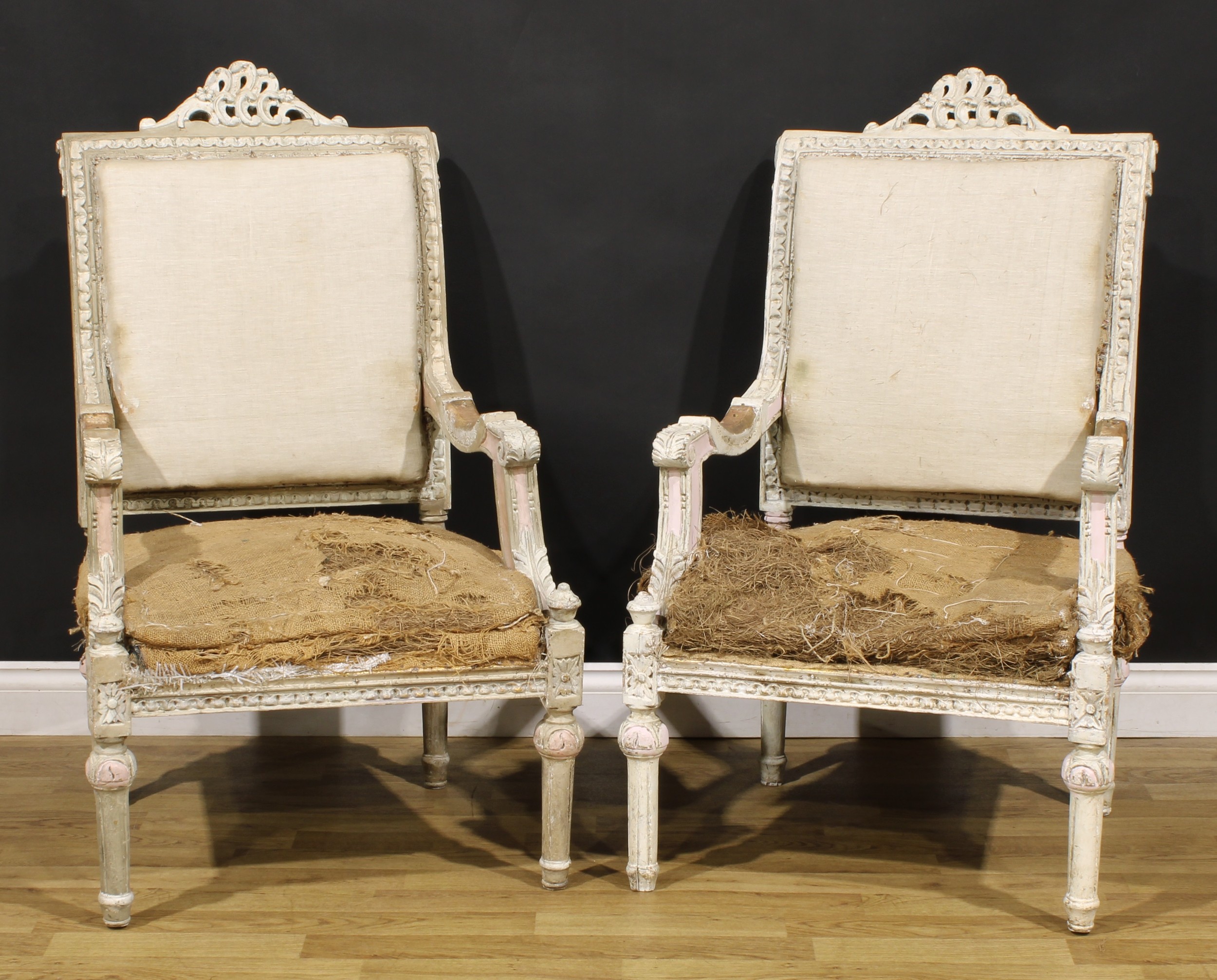 A pair of Louis XVI Revival painted armchairs, carved throughout in the traditional manner, fluted