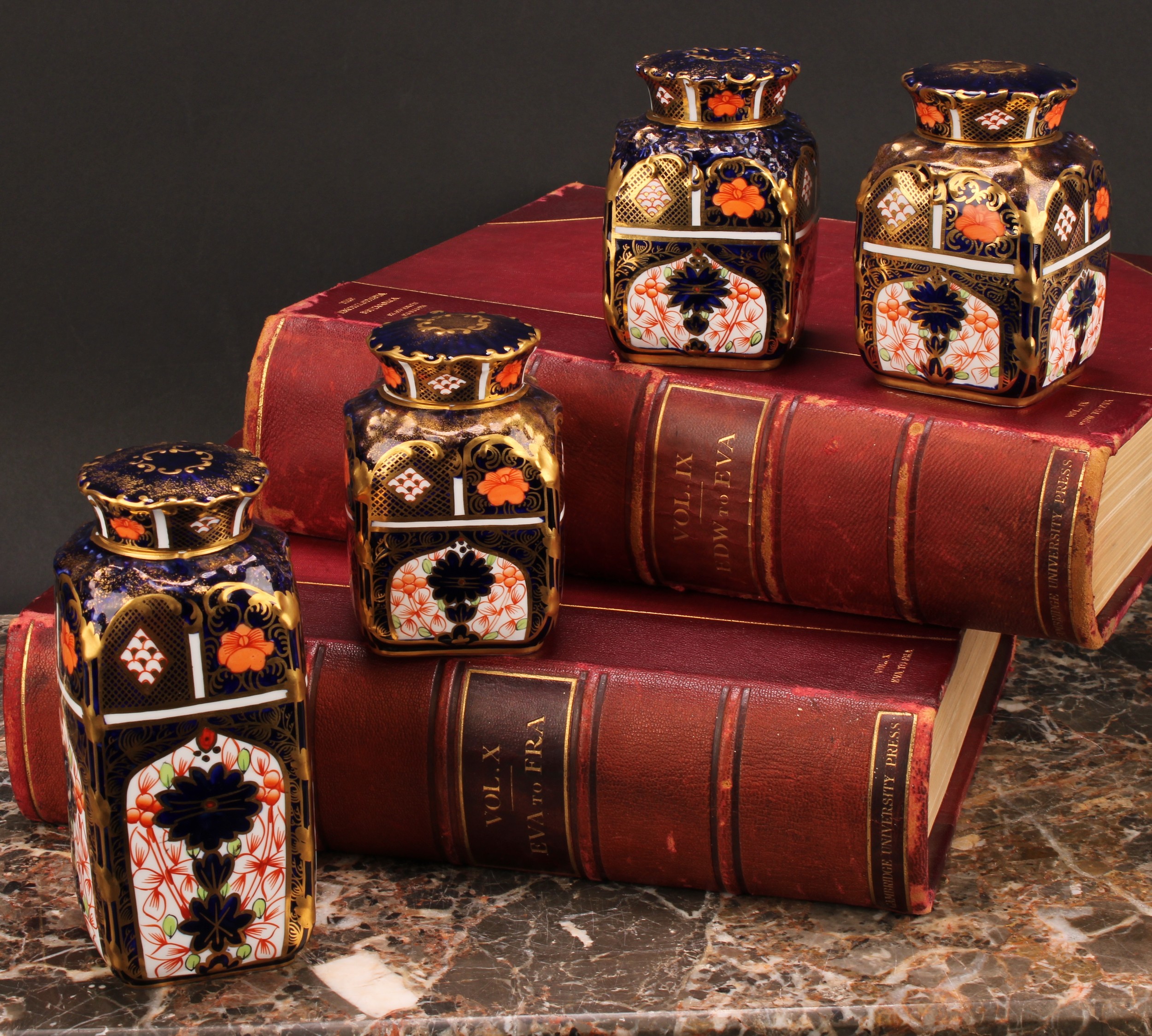 A set of three Royal Crown Derby 1128 pattern shaped rectangular caddies, shaped circular covers,