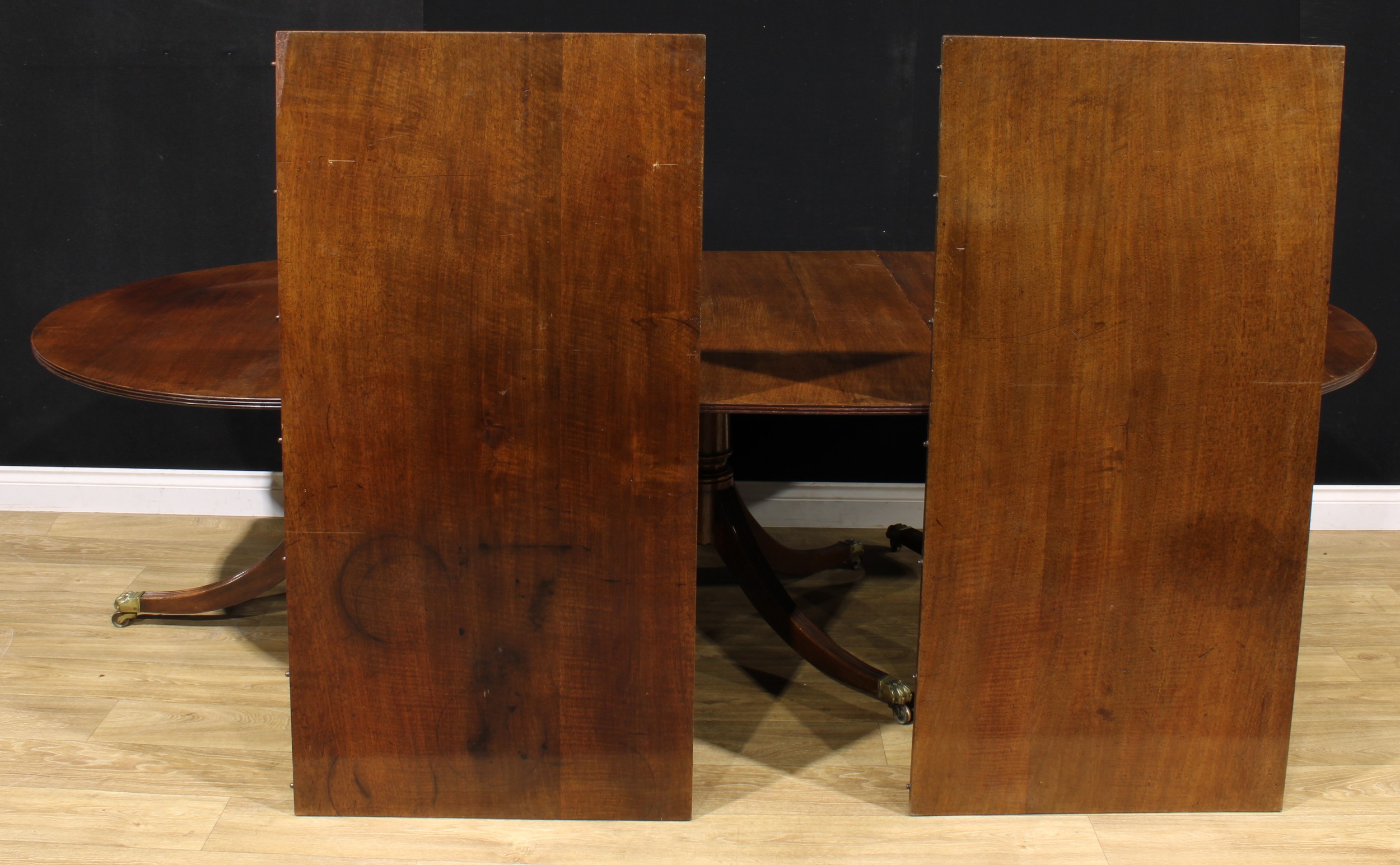 A large Regency Revival mahogany triple-pillar dining table, discorectangular top with reeded edge, - Image 3 of 3