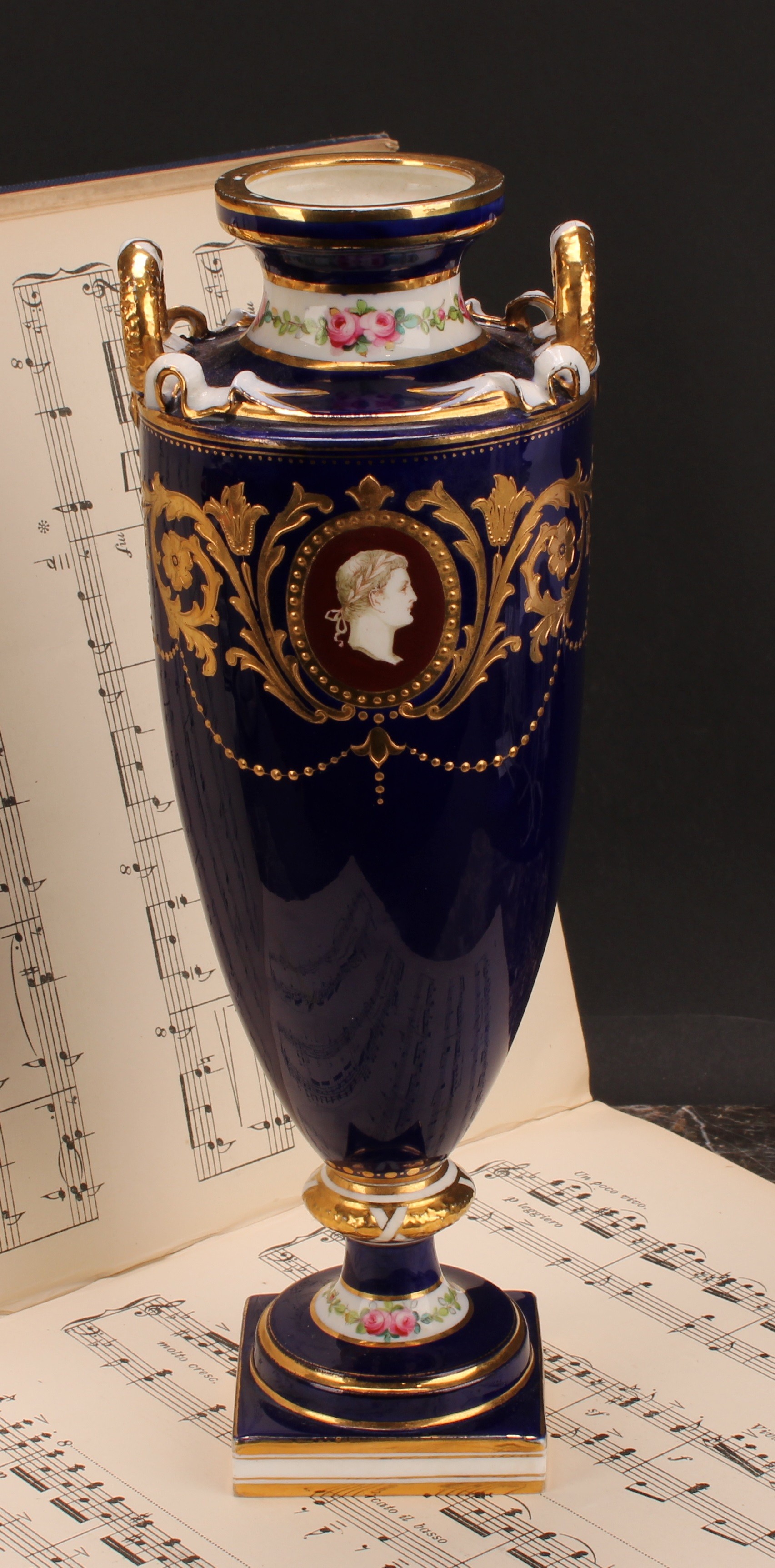 A Minton two-handled pedestal vase, painted with neo-classical portraits in raised gilt oval panels,