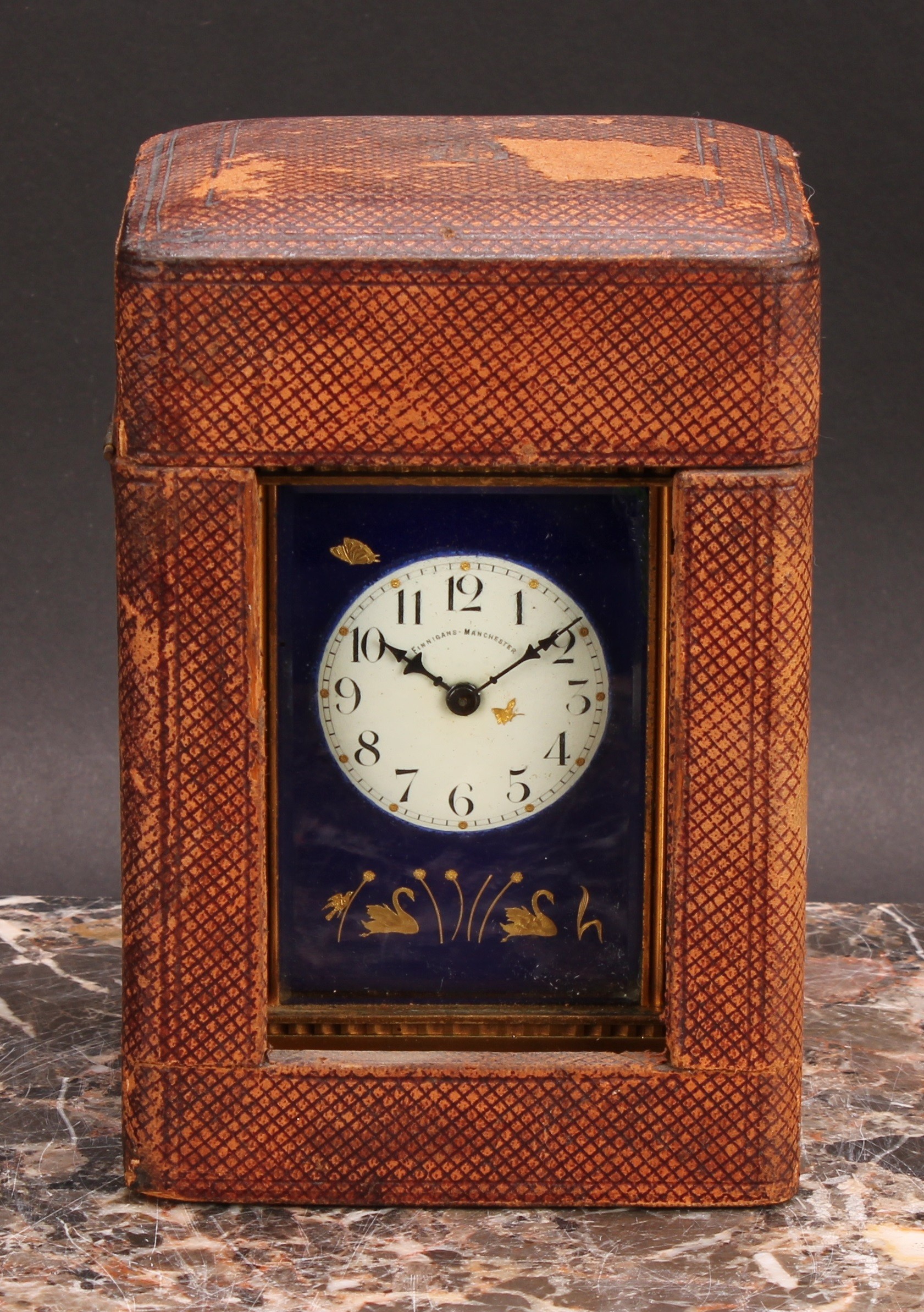 An early 20th century gilt brass carriage timepiece, 4.5cm enamel clock dial inscribed Finnigan’s,