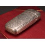 A Victorian silver rounded rectangular cigar or cheroot case, profusely engraved with scrolling