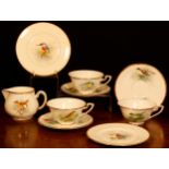 A set of three Royal Worcester teacups and saucers, painted by D. Jones, signed, with British birds,