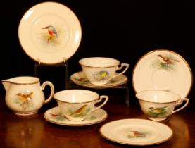 A set of three Royal Worcester teacups and saucers, painted by D. Jones, signed, with British birds,