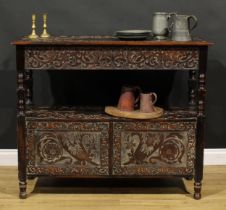 An Arts & Crafts period two-tier buffet serving table, drawer to frieze, doors to base, carved