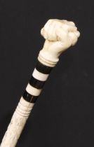 A 19th century sailor's maritime whale bone walking stick, the pommel carved as a fist grasping a