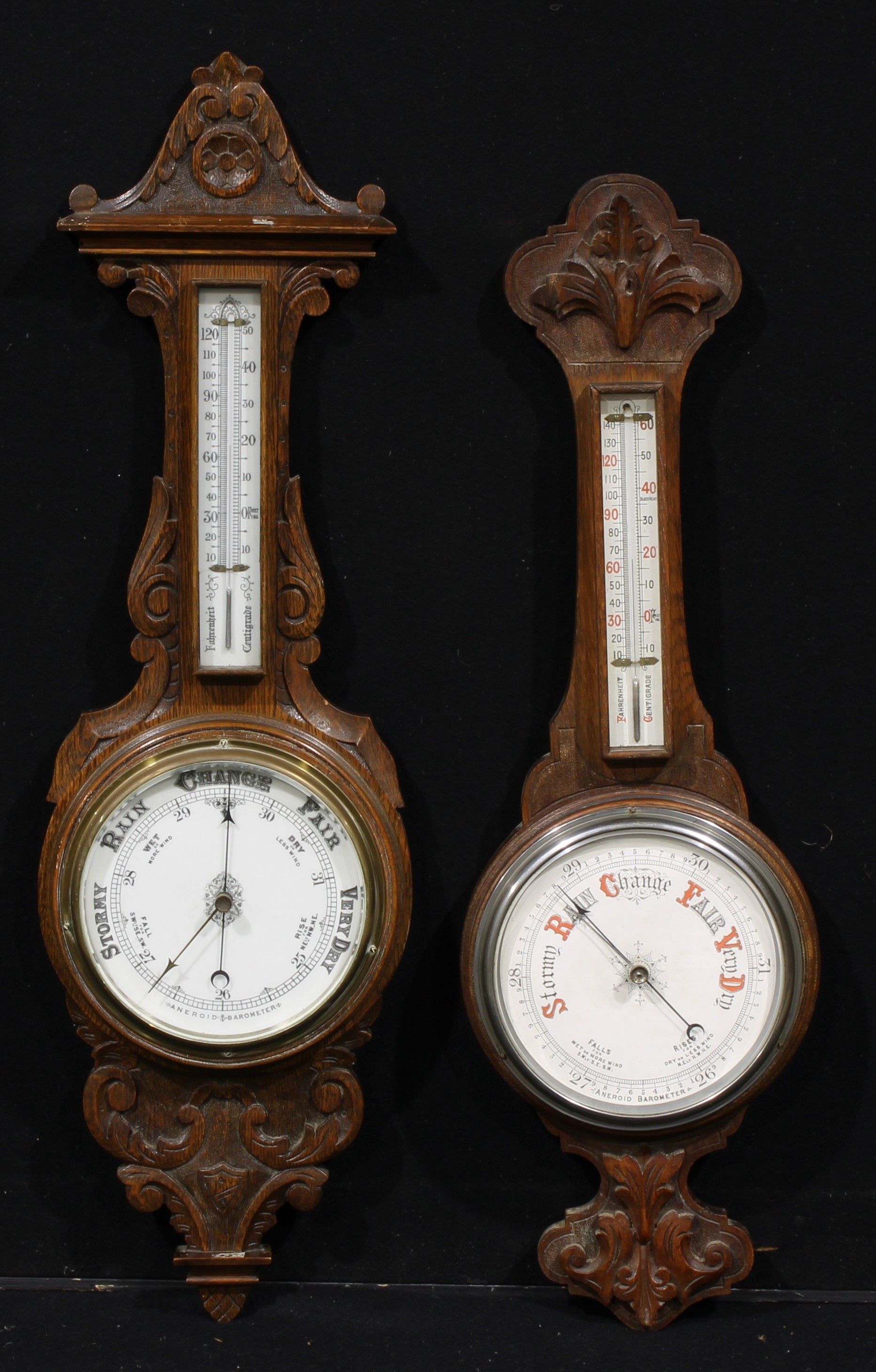 A late Victorian/ Edwardian oak wheel barometer, 19cm register, mercury thermometer, the case carved
