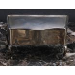 A George V silver serpentine dressing table jewellery box, hinged engine turned cover, cabriole