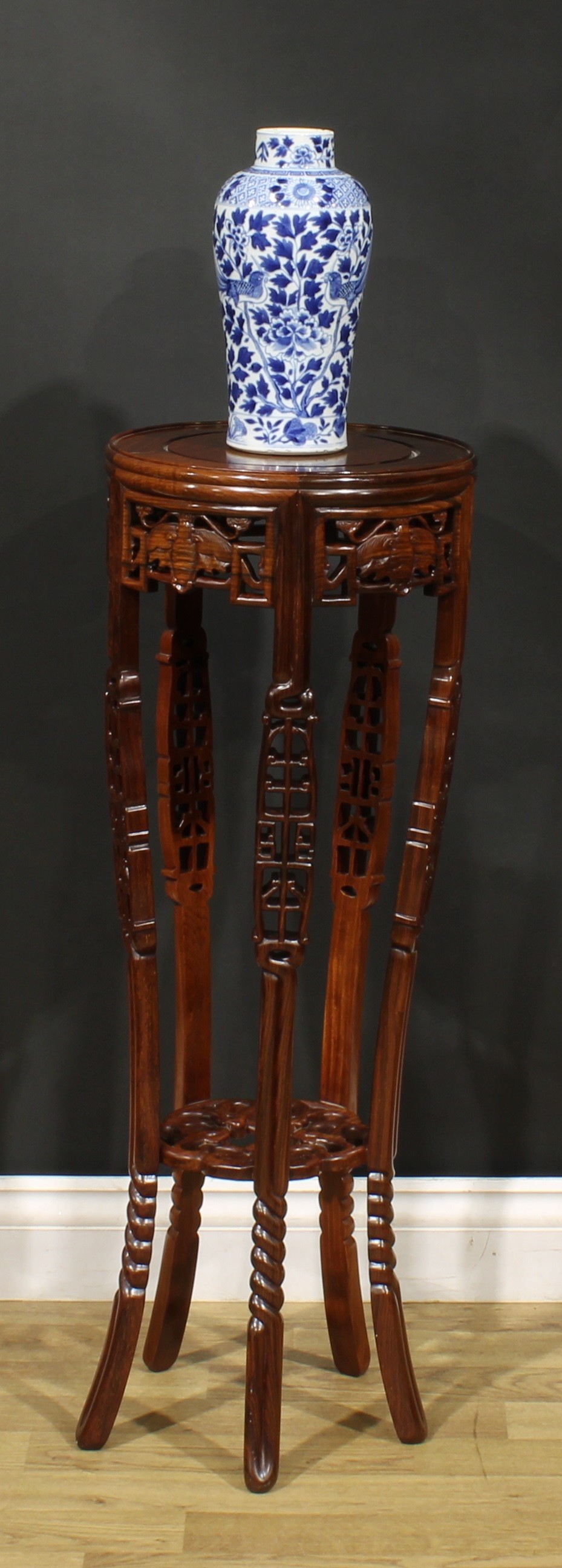 A Chinese hardwood jardiniere stand, pierced and carved with bats and scrolls, 87cm high, 30.5cm