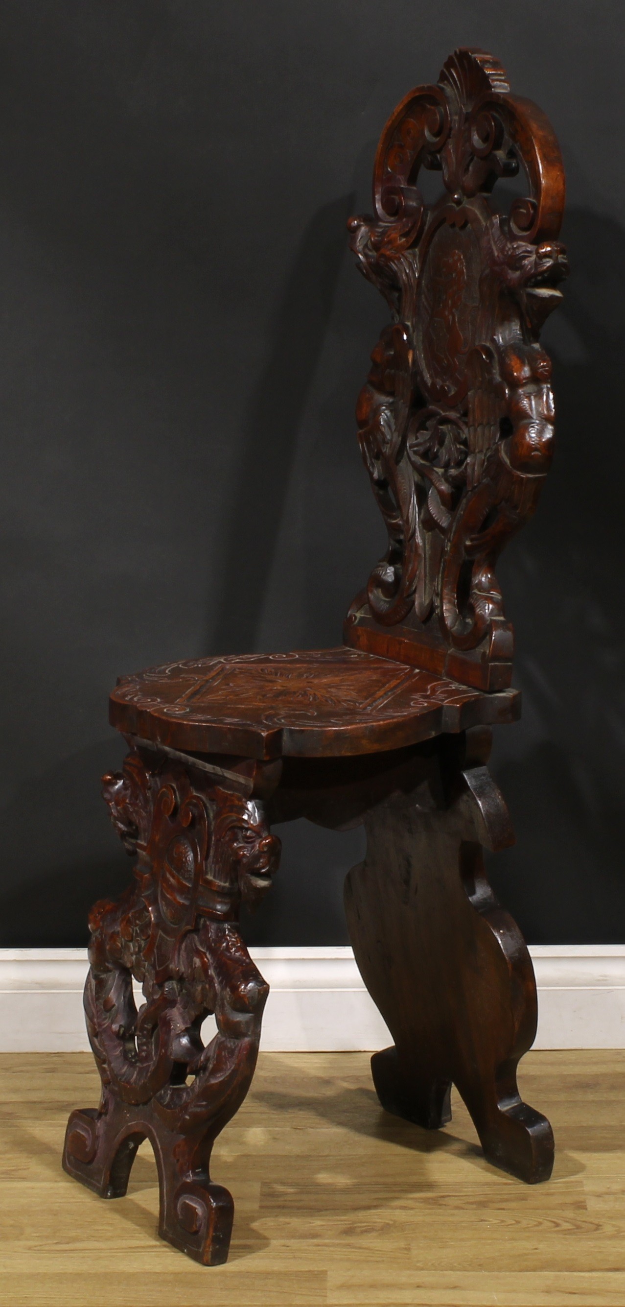 A pair of 19th century Italian walnut sgabelli or hall chairs, carved throughout in the - Image 4 of 9