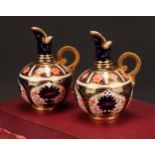 An associated pair of Royal Crown Derby 1128 Imari pattern globular ewers, gilt scroll handles, 12cm