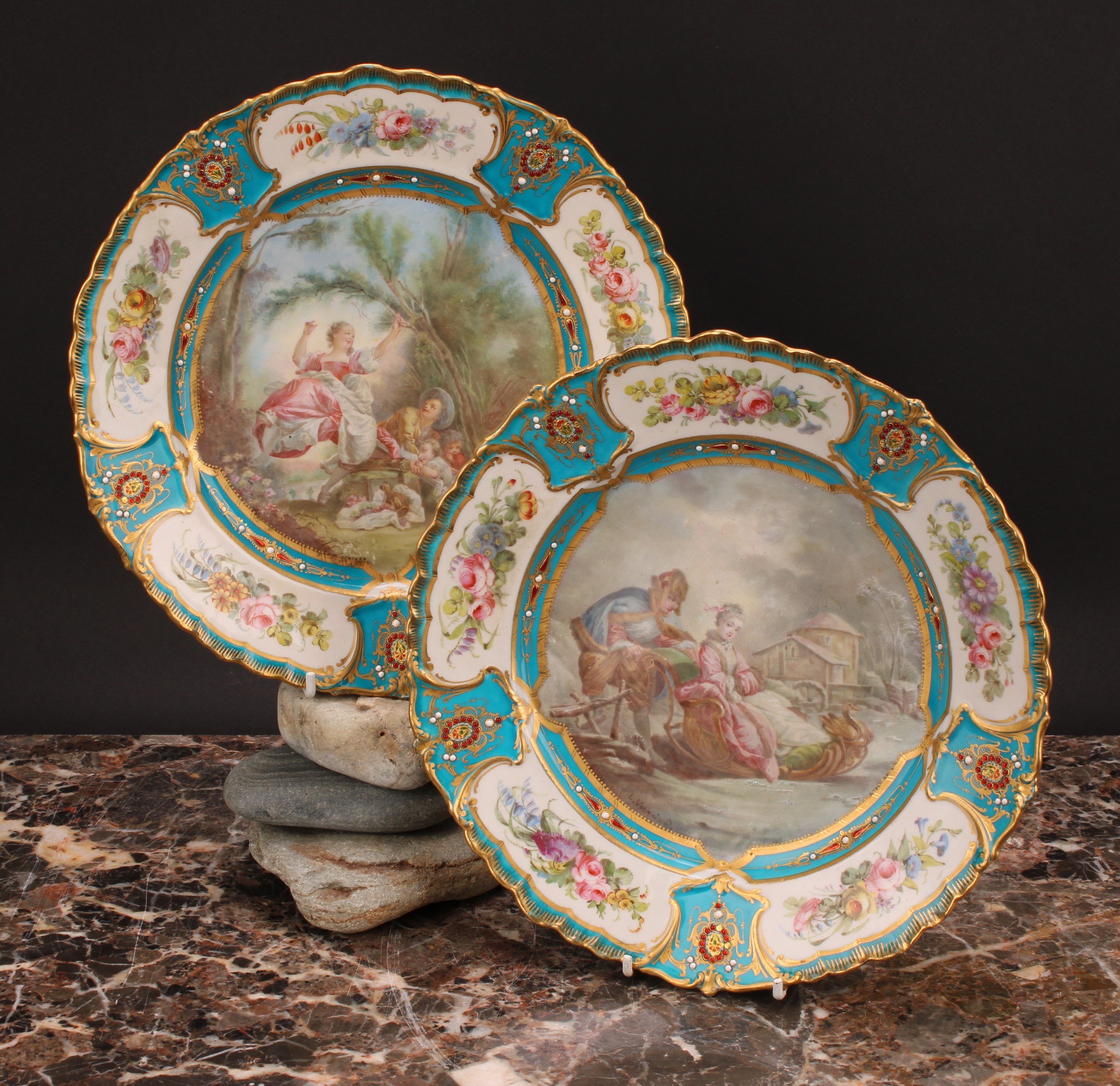 A pair of Sevres shaped circular plates, painted by L Vergniaud, signed, with a courting couple in a