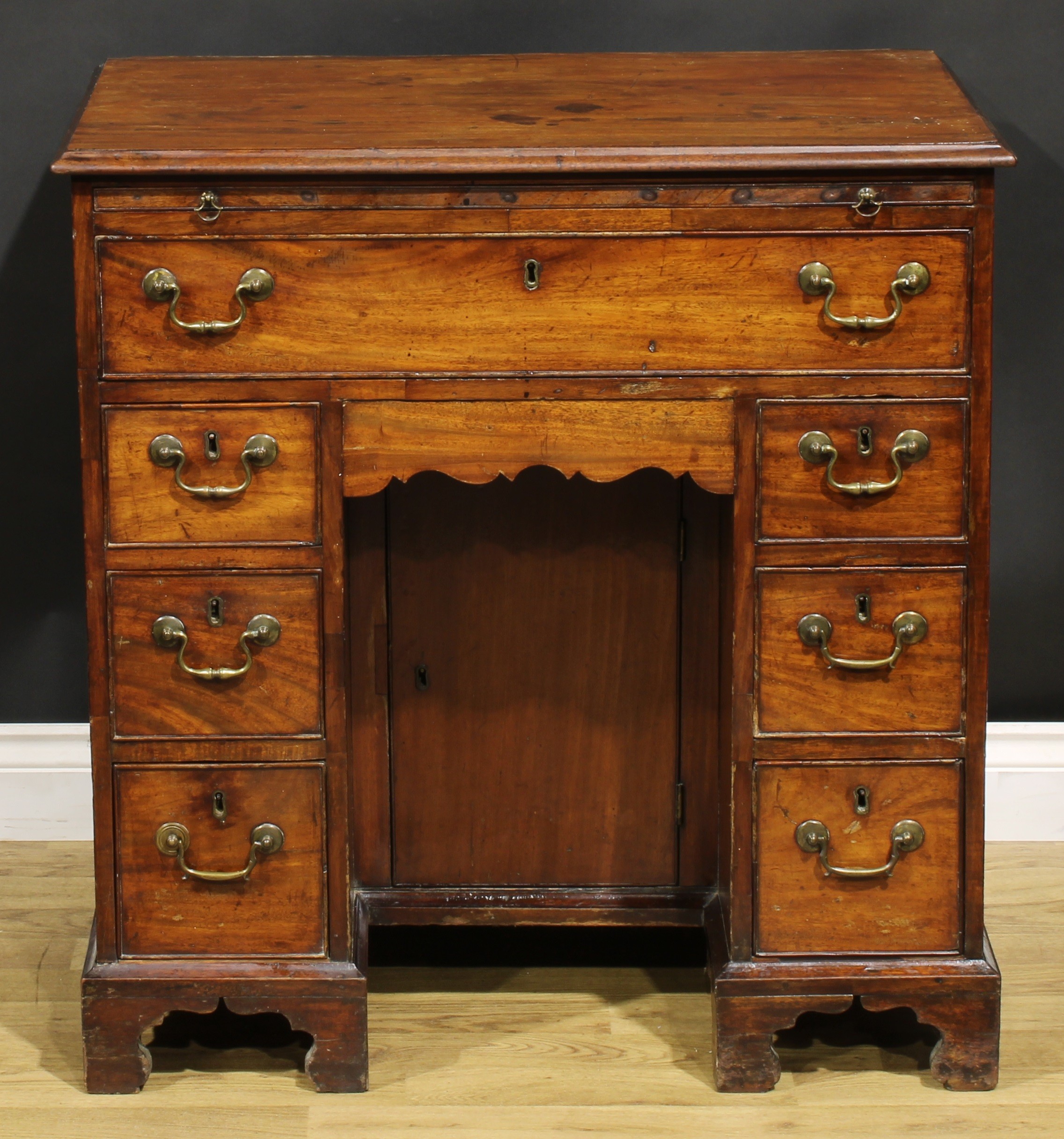 A George III mahogany kneehole desk, the ovolu moulded top above a brushing slide, axe head handles, - Image 2 of 8