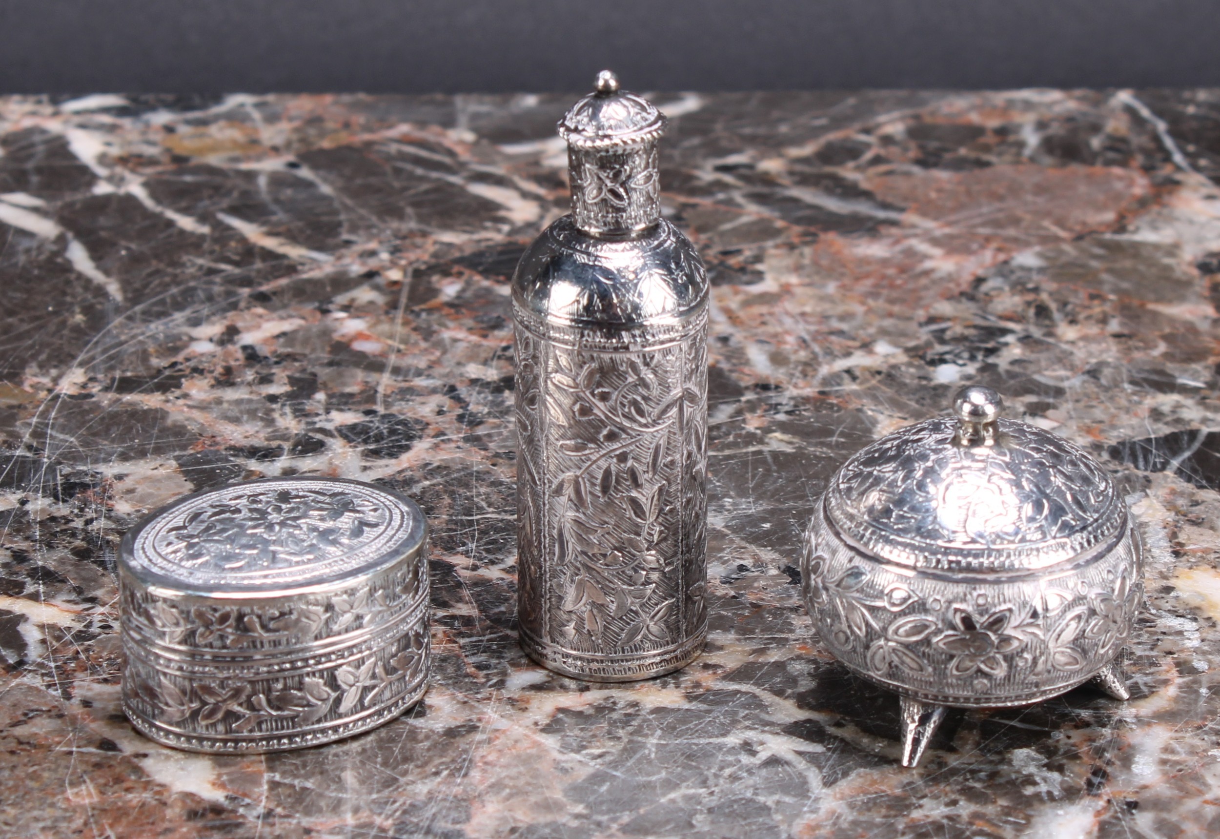 A Middle Eastern silver cylindrical kohl flask, chased with leafy branches, screw-fitting cover with