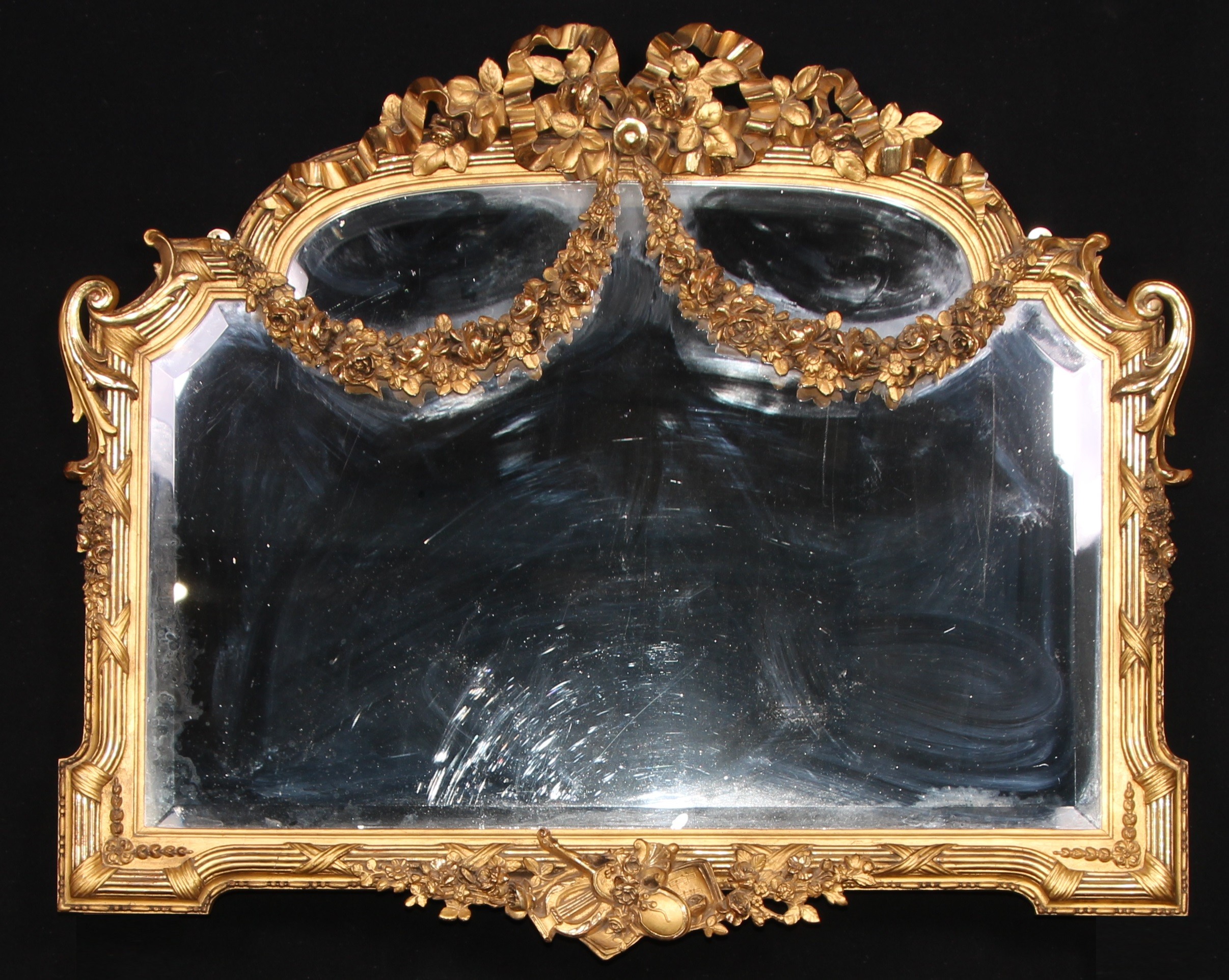 A Louis XVI Revival giltwood and gesso chimney glass, bevelled mirror plate, the frame applied