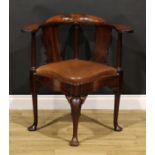 An 18th century mahogany corner elbow chair, possibly American, broad shaped arms, vasular splats,