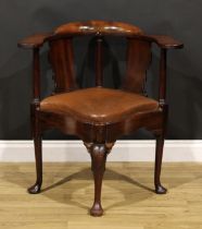 An 18th century mahogany corner elbow chair, possibly American, broad shaped arms, vasular splats,