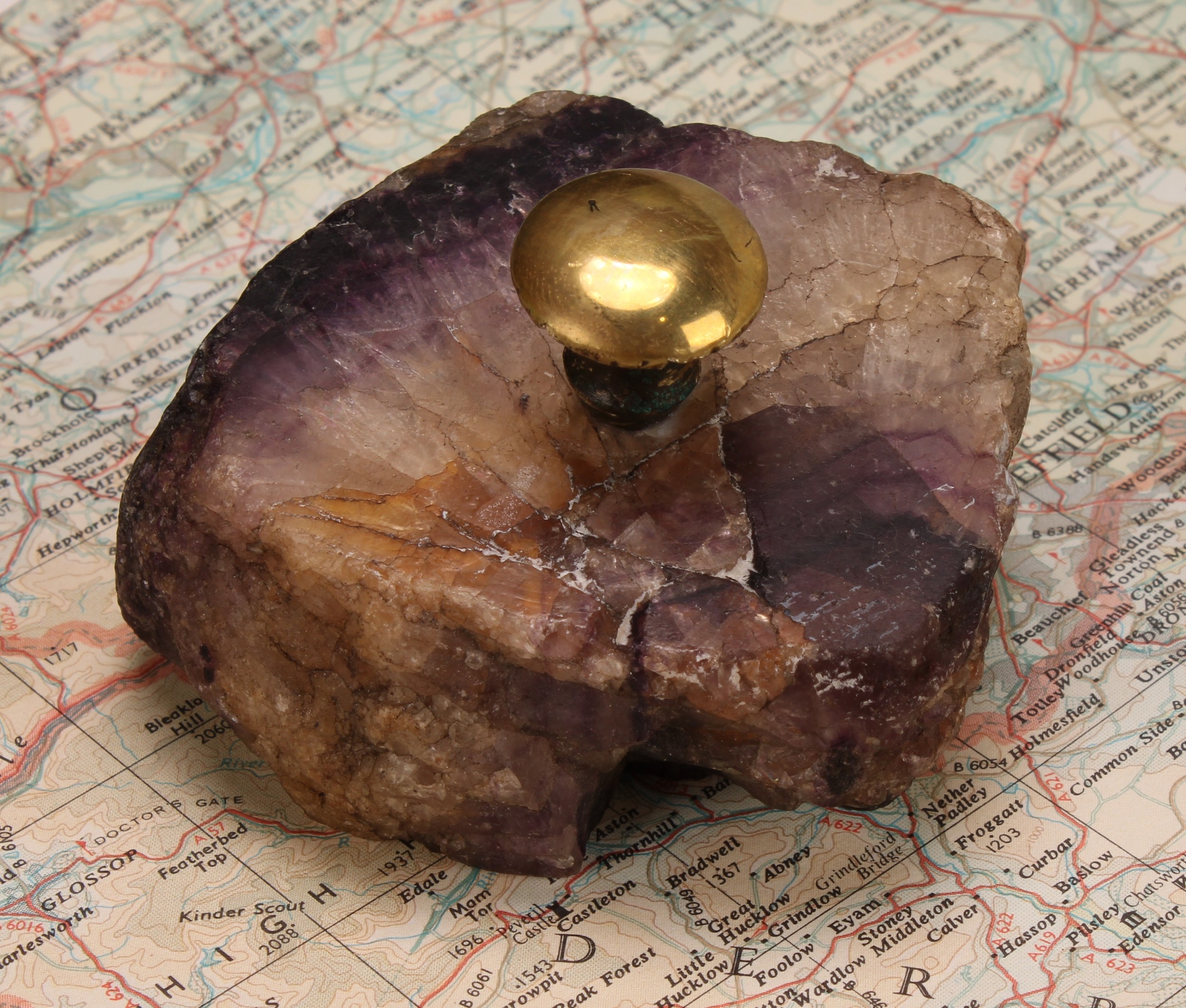 A 19th century Derbyshire Blue John specimen, as a desk weight, brass handle, 7cm wide