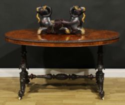 A Victorian Irish walnut and mahogany centre table, oval quarter-veneered top with carved edge,