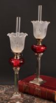 A pair of EPNS Corinthian column table oil lamps, frilled shades, fluted glass reservoirs, 54cm high