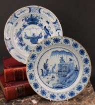 An 18th century Delft circular charger, painted in underglaze blue in the Chinese taste, with