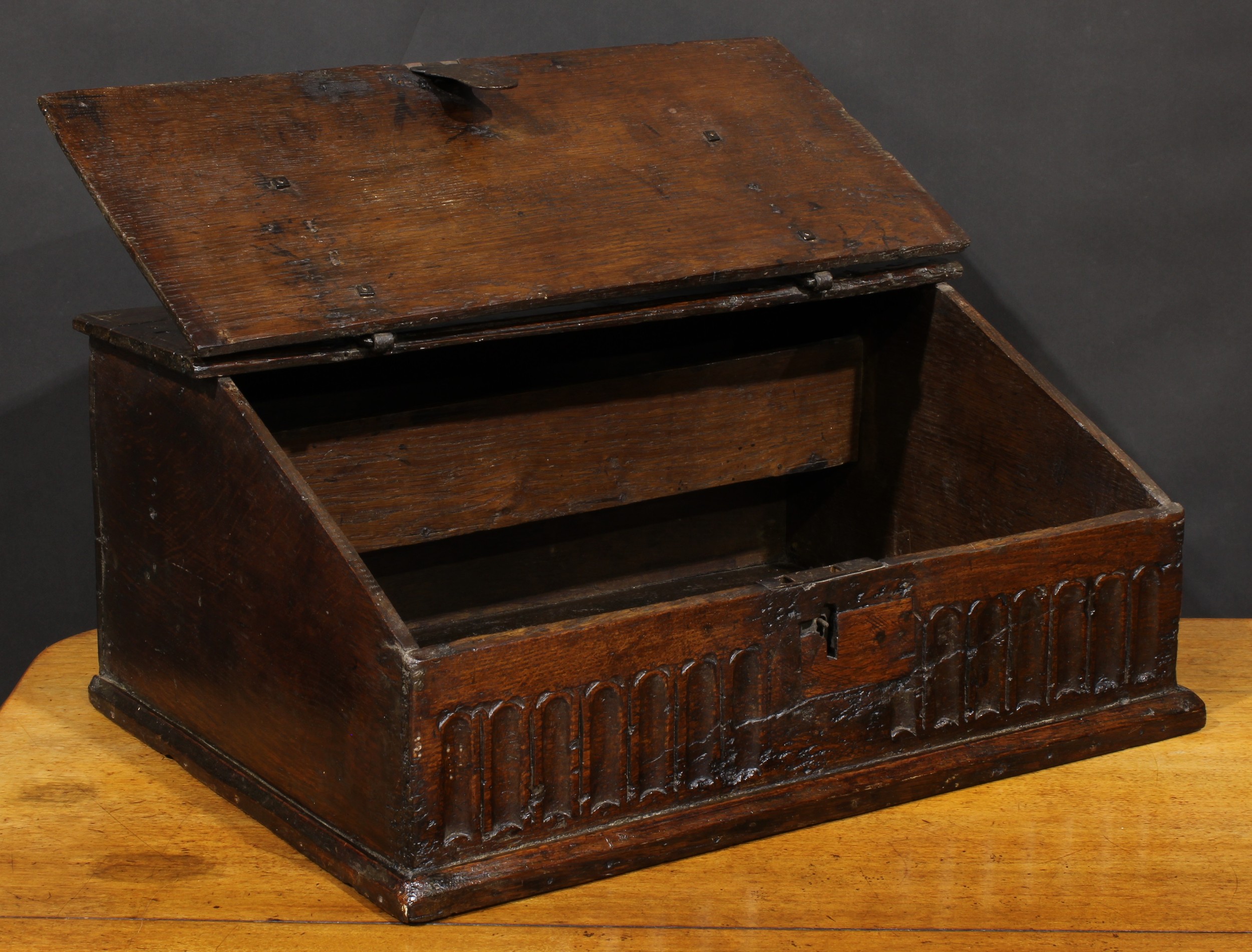 An 18th century oak boarded table box, hinged sloping top above a nulled frieze, 29cm high, 63.5cm - Image 3 of 4